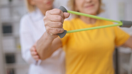 Close-up of a senior patient training her muscles as part of a rehabilitation program after an...