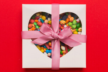 Box with sweet chocolate candies on color background, Various candy sweets. Valentines day gift...