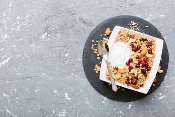 Healthy breakfast food with granola, yogurt, fruits and nuts. Dessert parfait with dried fruits for breakfast