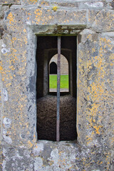 View through window and doors of the ruins of Rosserk friary in County Mayo, Ireland