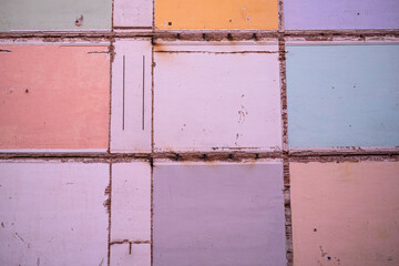 Several walls, painted in different colors, from old rooms, which were exposed when a building was knocked down.