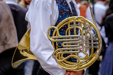 A boy holds a wind instrument under his arm, during the major festivals of Barcelona (SPAIN)
