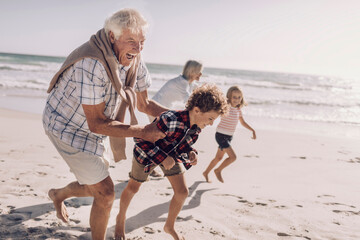 Grandparents and grandchildren having fun on the beach