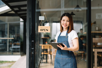 Startup successful small business owner sme woman stand with tablet  in cafe restaurant. woman...