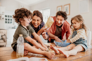 Family baking together in kitchen, kids and parents making cookies