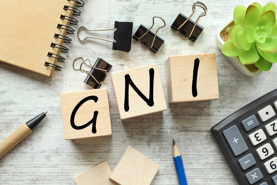GNI - short for Gross national income. wooden blocks with text. in the middle of the table