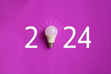 2024 created from led light bulb on color background. Creativity inspiration ,planning ideas concept
