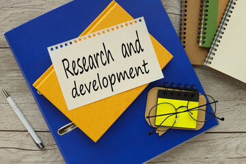 Business Acronym RD as Research and Development. text on the page. yellow notepad on blue folder