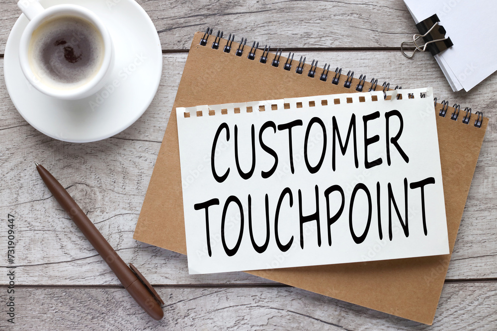Poster customer touchpoint text on notepad page. craft notebook on the work table