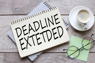 DEADLINE EXTENDED glasses on a green sticker. text on notepad page - obrazy, fototapety, plakaty