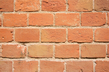 Old italian exposed brick wall after an architectural restoration - Bricks positioned in the smallest dimension called a head