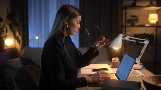 Tired Young Woman Freelancer Feeling Annoyed During Study or Work at Home Workplace at late Night