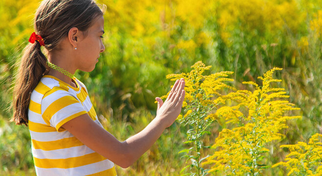 A child is allergic to ragweed blooming in the park. Selective focus.