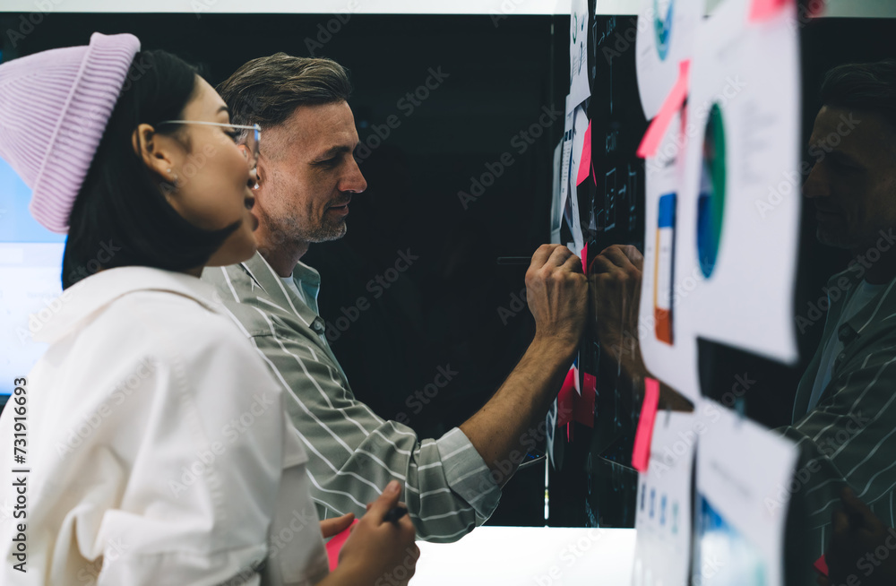 Poster competitive colleagues analyzing analytic statistics and graph charts during working process in offi