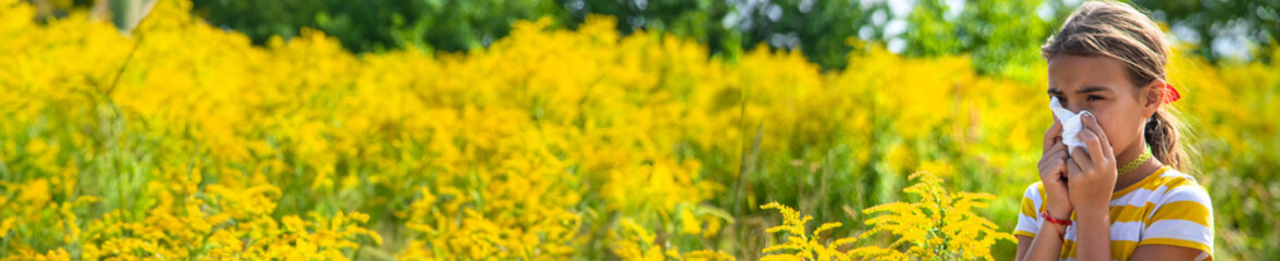 A child is allergic to ragweed blooming in the park. Selective focus.