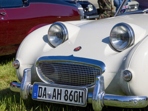 Weiterstadt, Germany September 24, 2023: Austin Healey Sprite in white at Chromblitz in Weiterstadt at Braunshardt Castle; spoke rims