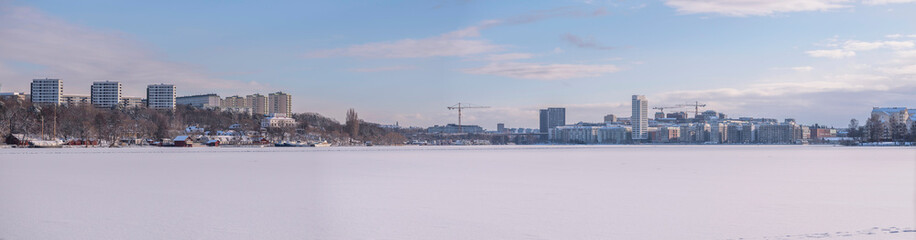 Panorama snowy winter view over the bay Bällstaviken, the districts Solna and Kungsholmen in Stockholm