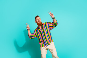 Photo of cheerful red hair beard male model hipster showing double v sign looking empty space...