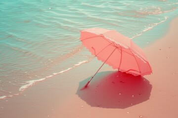 a pink parasol on sandy beach, minimal summer concept