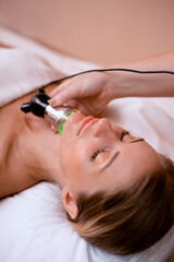 renewal for neck skin with electric mesotherapy device to decrease wrinkles on woman face in beauty...