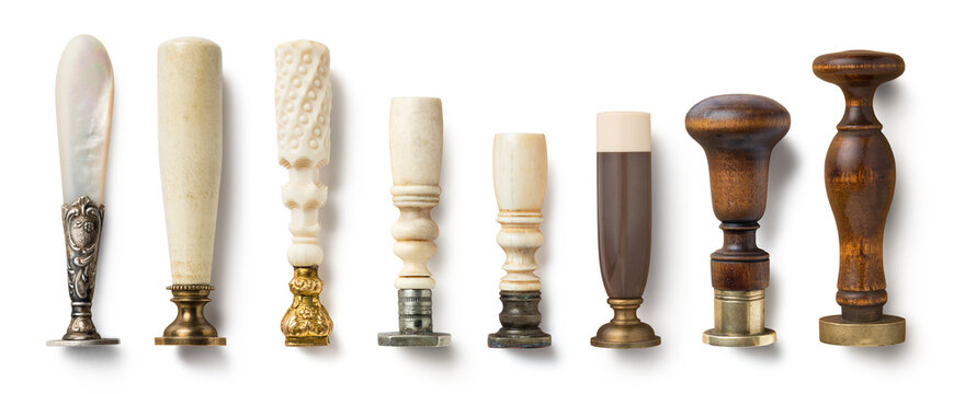 set of vintage and antique desk seals / stamps with ornate handles isolated over a transparent background, cut-out wedding stationery scene design elements, top view / flat lay, PNG