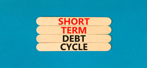 Short term debt cycle symbol. Concept words Short term debt cycle on wooden stick. Beautiful blue table blue background. Business Short term debt cycle concept. Copy space.