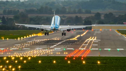 Fotobehang landing at the airport, landing on a runway, plane lands on a runway © Justyna