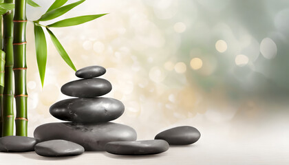Spa stones with bamboo branches on light background with copy space