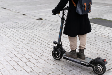 Mobility. Citizen with electric scooter in pedestrian zone
