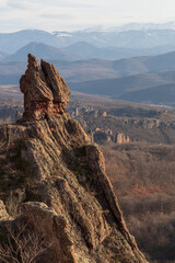 A scenic landscape of the Belogradchik Rocks and mountains in Bulgaria with impressive rock formations with amazing light at golden hour in winter. Belogradchik, Bulgaria