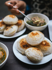 Traditional Vietnamese Mini Pancake. Vietnamese Street Food in Da Lat city, Vietnam. Banh can on the warm ember stove kitchen. Food and travel concept.