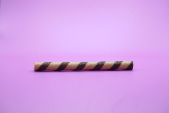 wafer stick isolated purple background. a chocolate flavored wafer stick.