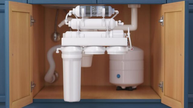 Reverse osmosis water purification system under sink in a kitchen. Water cleaning system installation. process.