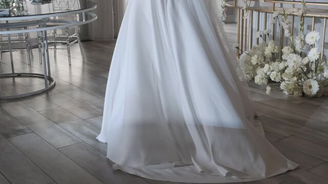 the hem of a woman's wedding dress at the moment when the bride is spinning