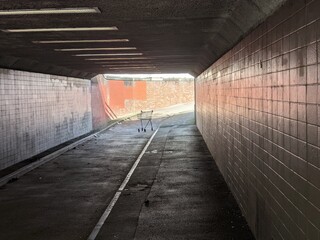 An abandoned shopping trolley at the end of an urban subway