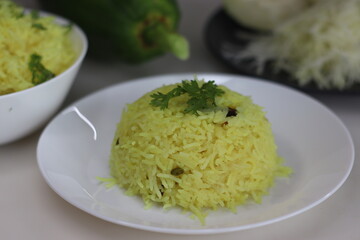 Spiced papaya rice. A quick stir fried rice recipe with green papaya, turmeric and a tadka of spices and nuts to make a one pot meal