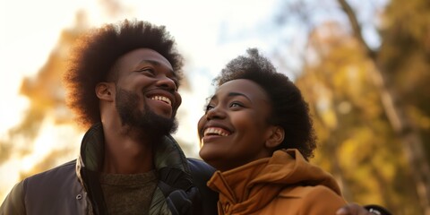 Smile, nature and bottom portrait of black couple on a valentines day date in a garden or park. Happy, love and young African man and woman bonding on adventure in outdoor field from below together.