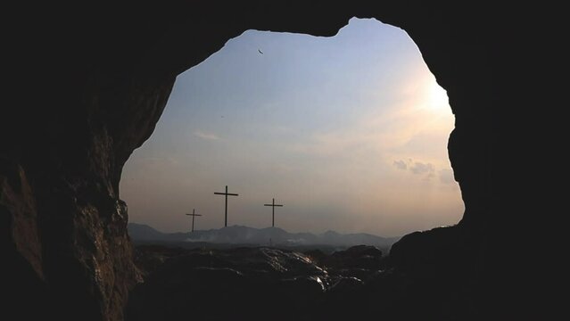 Three crosses on the hill and Jesus tomb Easter, resurrection, new life, redemption concept.