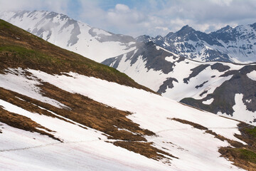 Picturesque panoramic view of the snowy Alps mountains while hiking Tour du Mont Blanc. Popular...