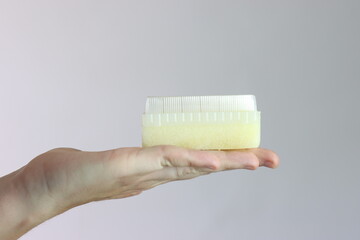 Surgical sponge in a woman’s hand in a light background 