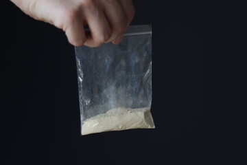 Woman holding a drug powder in a pack