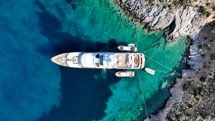 Aerial drone photo from tropical exotic paradise secluded rocky island bay with deep turquoise and...