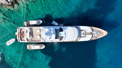 Aerial drone top down photo with copy space of luxury yacht anchored in tropical exotic island with...