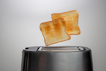 Modern toaster with crispy bread slices, closeup