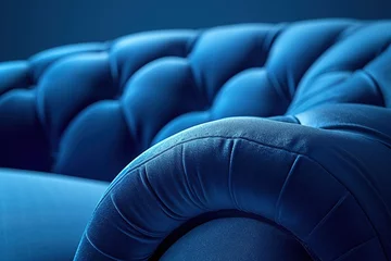 Foto op Canvas Upholstered furniture made of velor blue fabric with rounded elbows close-up. An element of upholstered furniture with a stitched sidewall in deep shadows with an empty space for text with cop. © interior