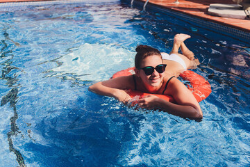Portrait beautiful young asian women happy smile relax outdoor swimming pool in resort hotel for vacation travel.