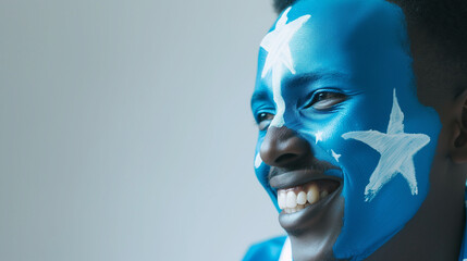 Somalia flag face paint, Close-up of a person's face, symbolizing patriotism or sports fandom. - obrazy, fototapety, plakaty