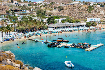 Psarou beach in Mykonos, Greece, umbrella and luxury beach services. Psarou beach is the favorite of international stars, truly a paradise with spectacular landscape and all its comforts