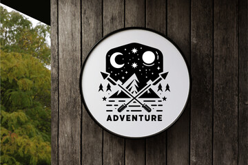 Black Mountain Adventure Logo in Circle White Signboard on the empty Wood Wall
