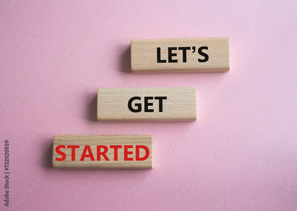Canvas Prints lets get started symbol. concept words lets get started on wooden blocks. beautiful pink background.